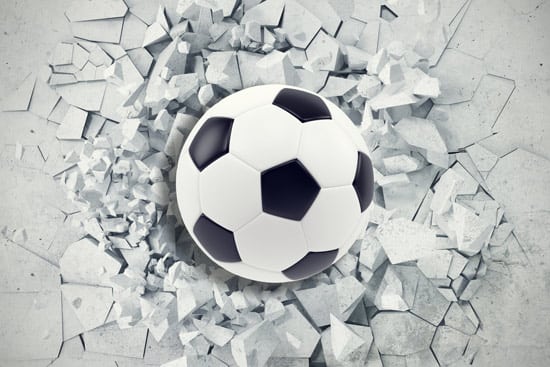 מדבקת טפט | כדורגל פורץ מתוך הקיר